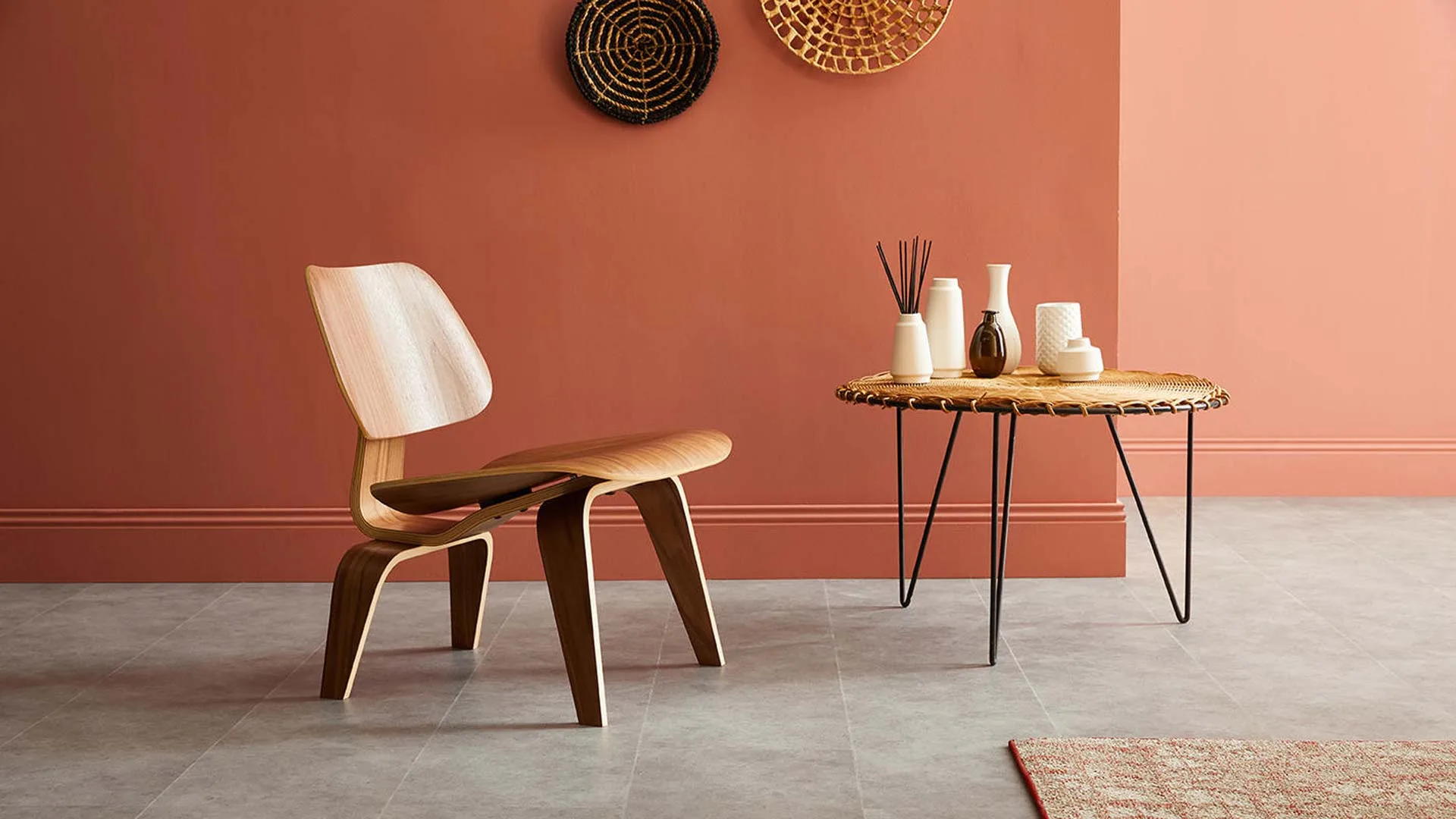 interior design of a cozy red space with wooden chair and side table